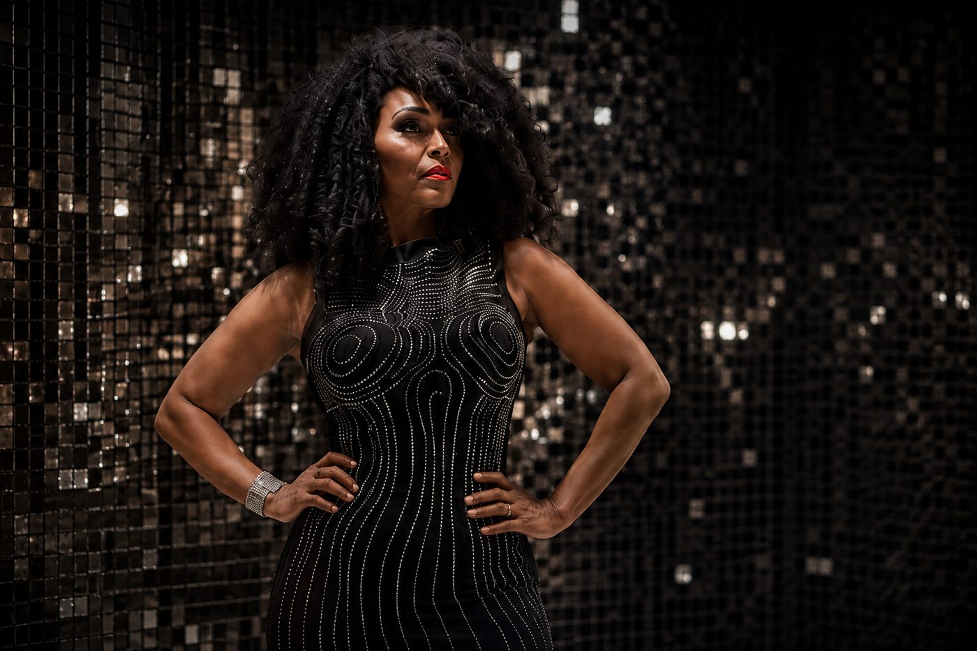 The vocalist against the sequin backdrop.